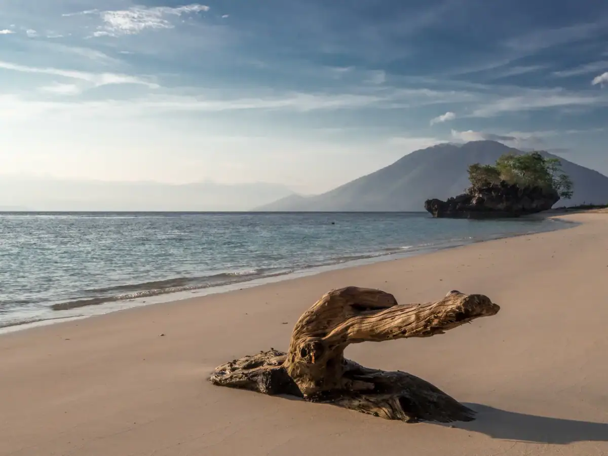 Beach and volcanic island across the Pantar Strait near Alor