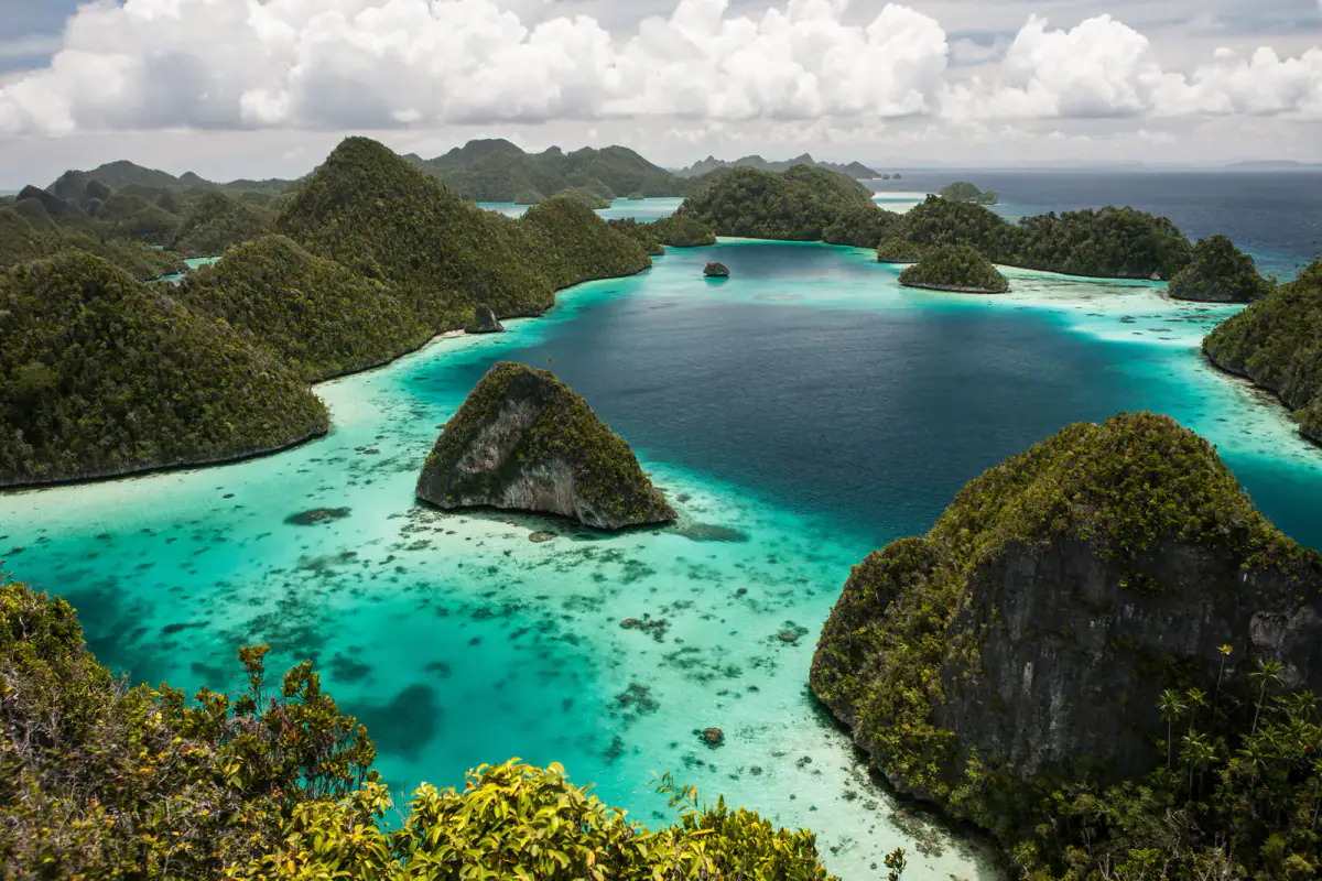 Karst islands rising from a turquoise lagoon at Wayag, Raja Ampat